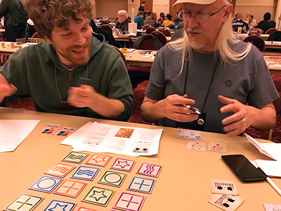 Two people playtesting a tabletop game